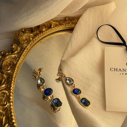 Sapphire Blue Four-Stone Drop Earrings Gold Tone — close-up of pearl and post detail