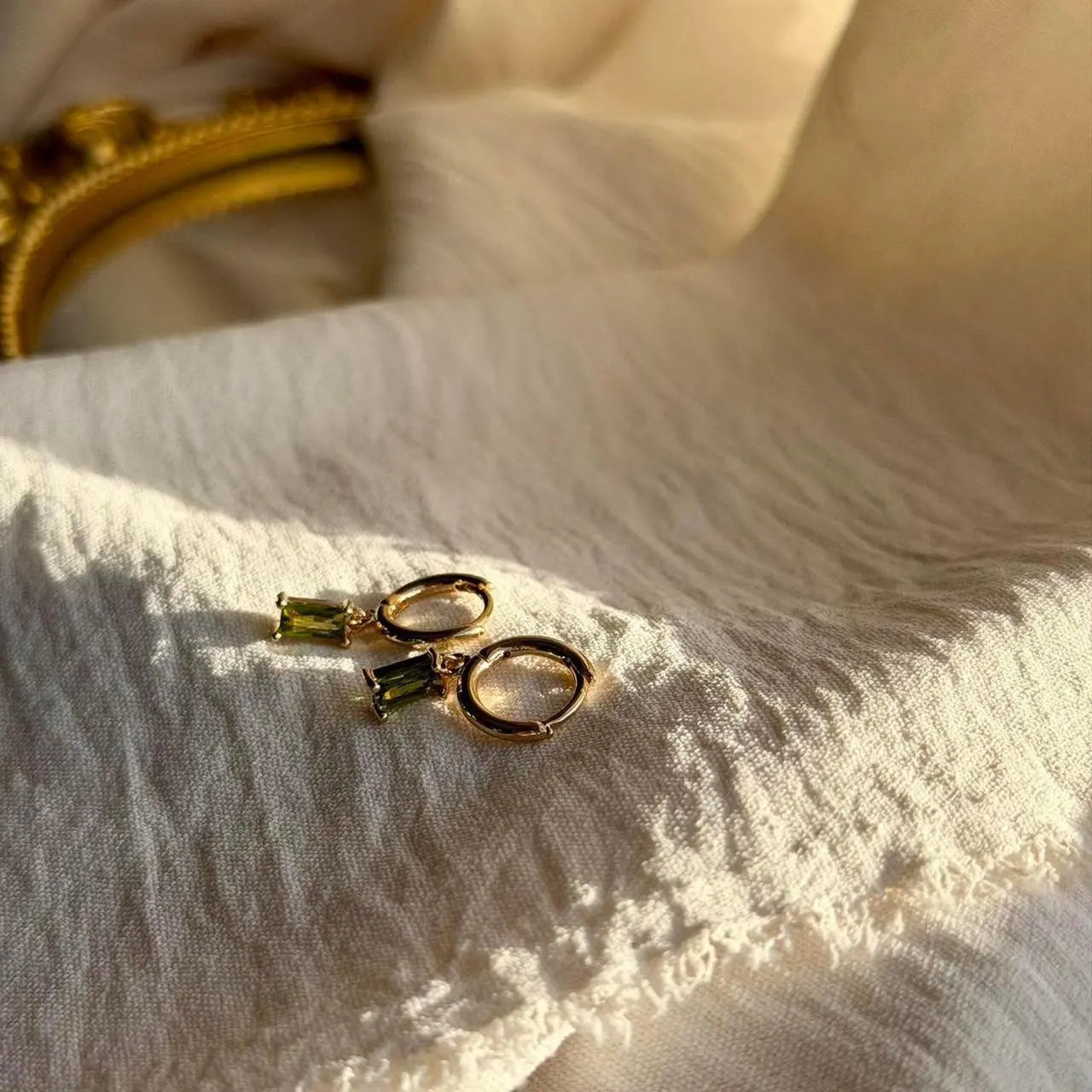 Olive Green Baguette Crystal Huggie Earrings 14K — pair shown together on flat lay