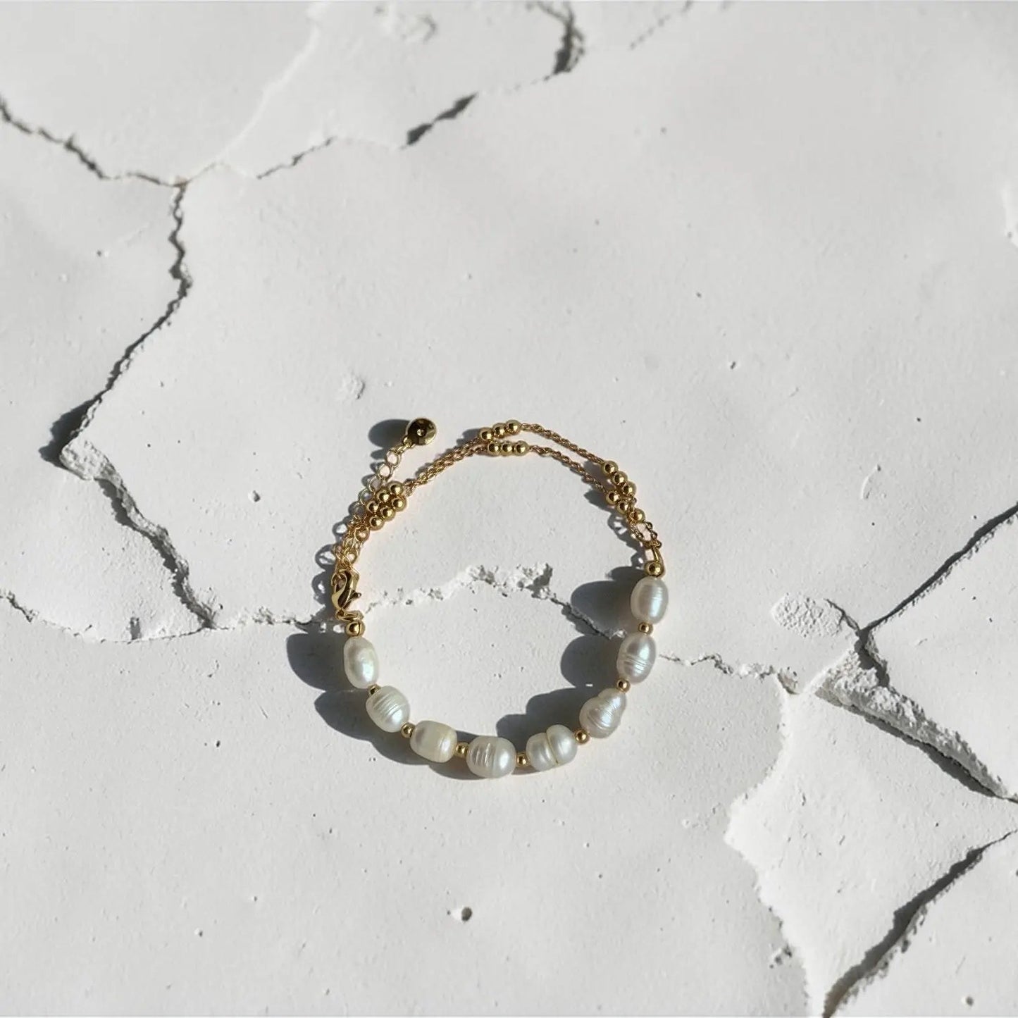 Freshwater Pearl Station Bracelet 18K Gold Plated on neutral background — full length view