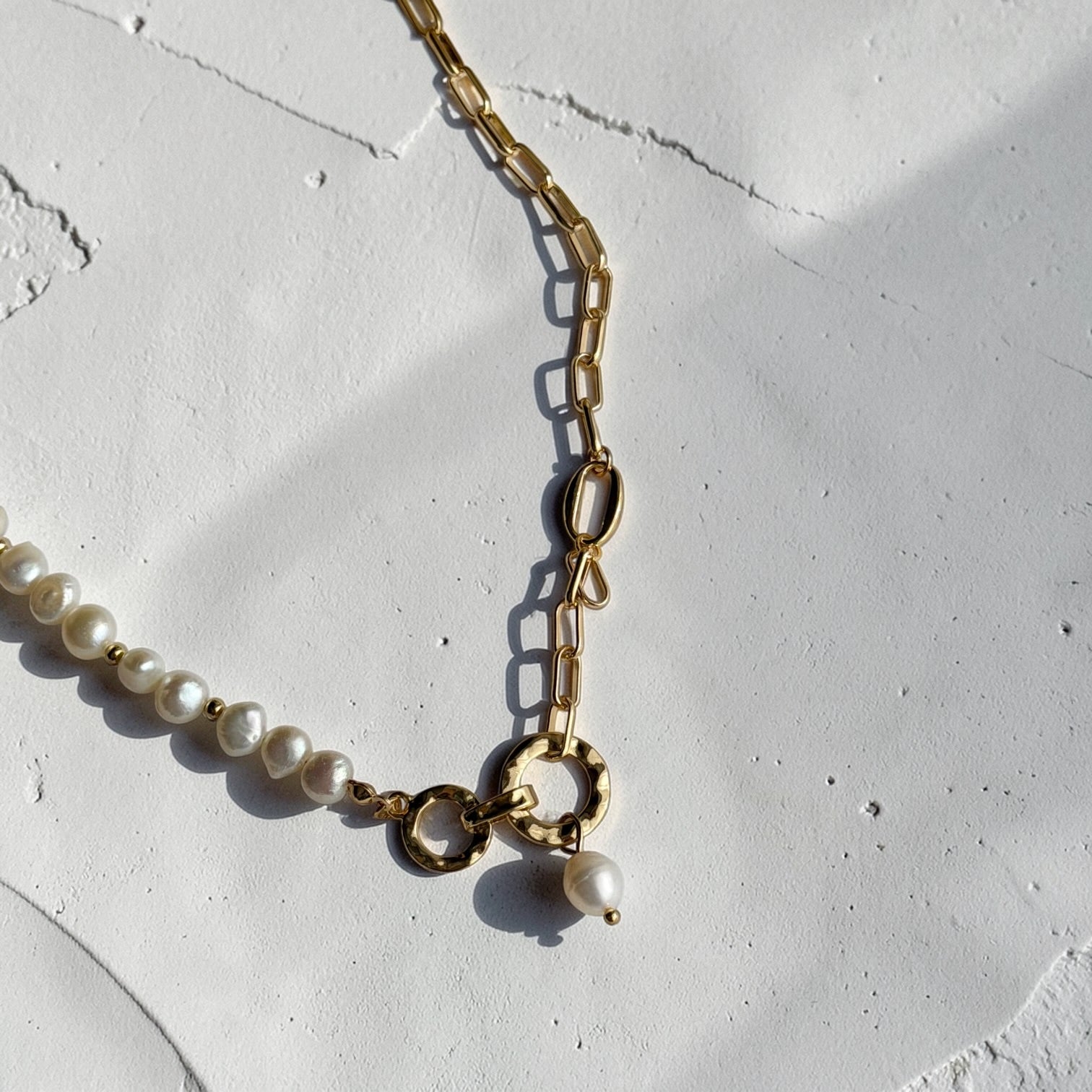Freshwater Pearl Asymmetric Chain Necklace Gold — styled flat lay with textures
