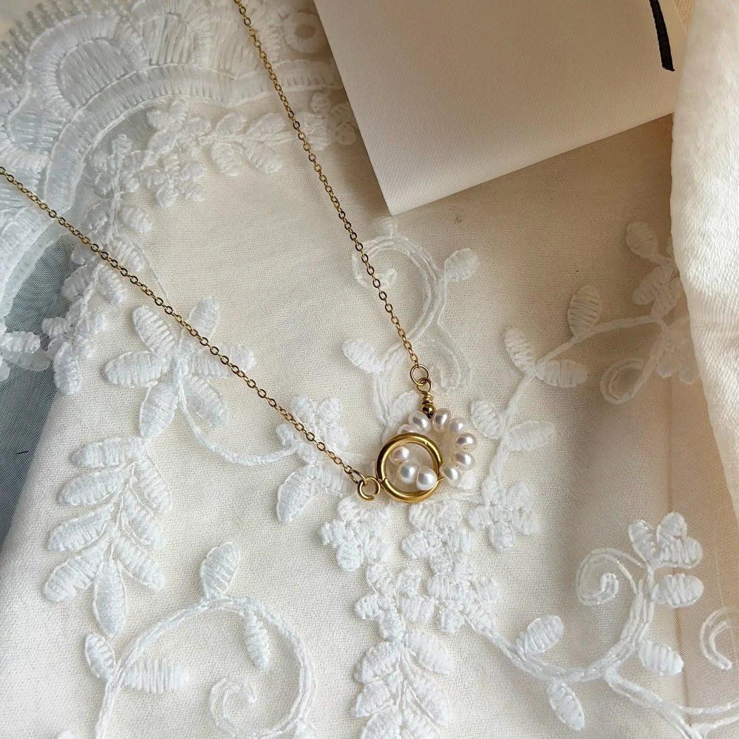 Freshwater Pearl Starburst Station Necklace Gold — styled flat lay with textures