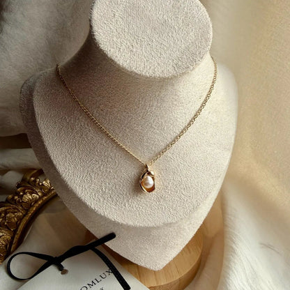 Freshwater Pearl Oval Pendant Necklace Gold Plated — styled flat lay with textures